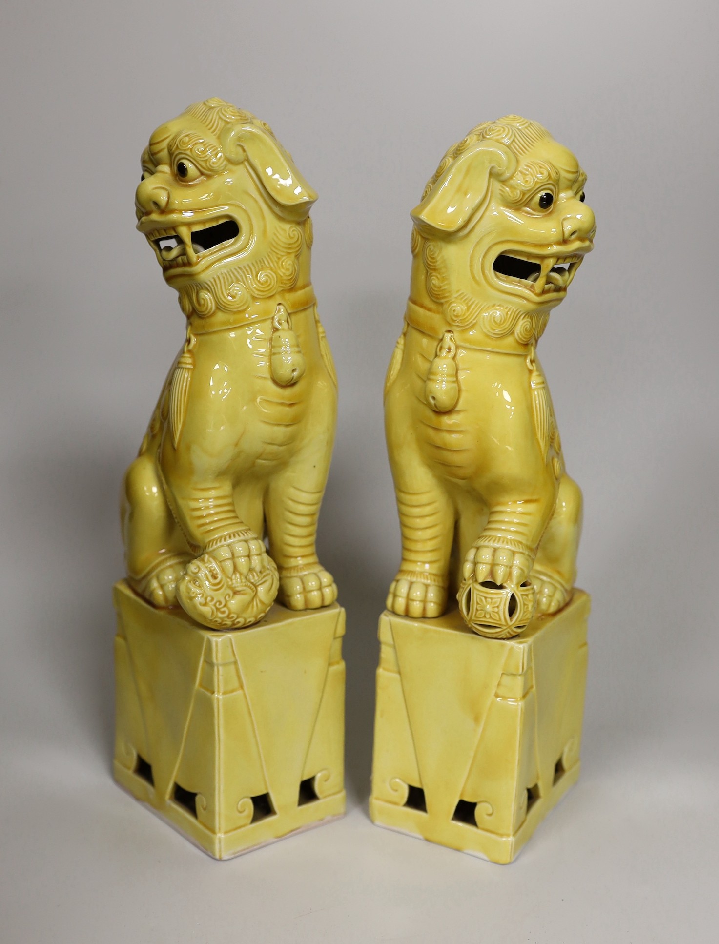 A pair of Chinese yellow glazed temple lion dogs 30cm